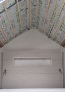 Aménagement d'un grenier à Charleroi - Placement du gyproc sur la tête de lit